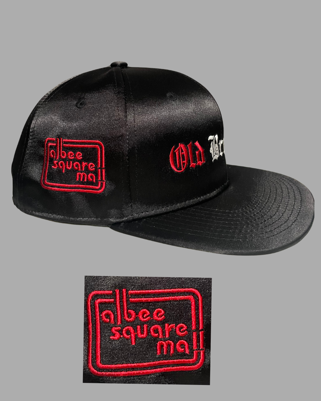 Black cap with red text saying 'Albee Square Mall' on a gray background
