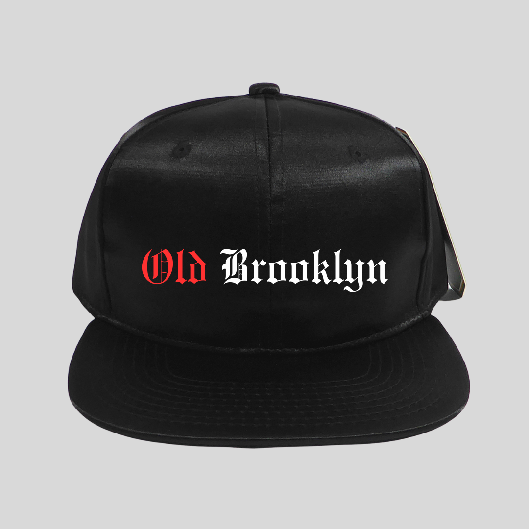 Black cap with 'Old Brooklyn' text on a gray background