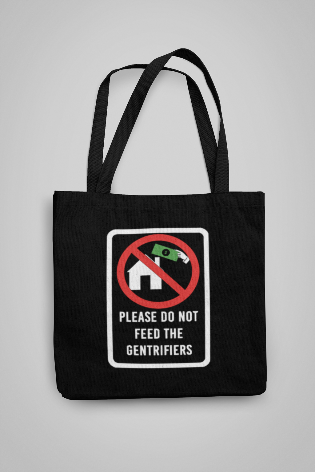 Black tote bag that says "Please Do Not Feed The Gentrifiers"